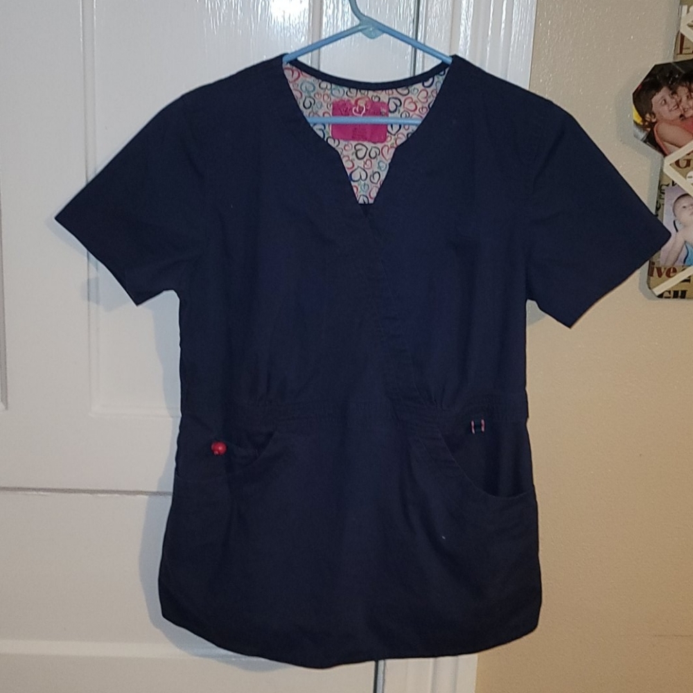 Dark blue nurses scrub shirt .